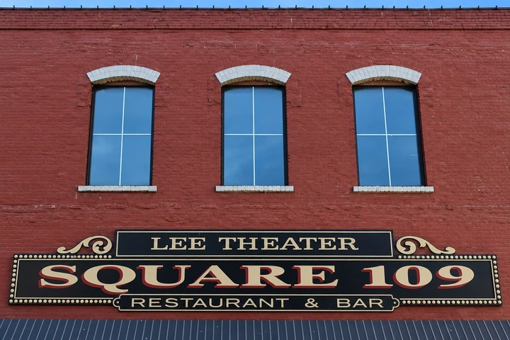 The red brick Lee Theater building and its historic Square 109 sign on Washington Street.