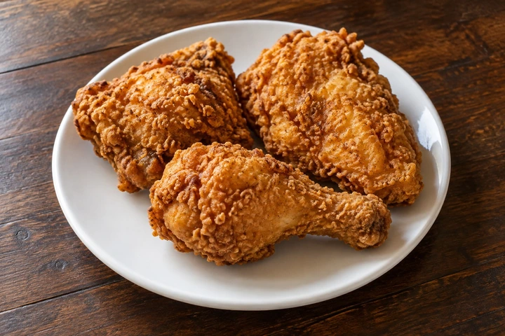 Illustrative plate of golden fried chicken.